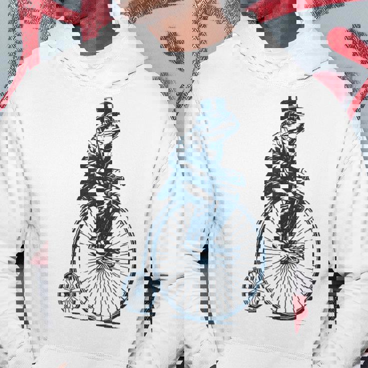 ビンテージのペニーファージング自転車に乗る粋なカエルのサイクリスト パーカー 面白い贈り物