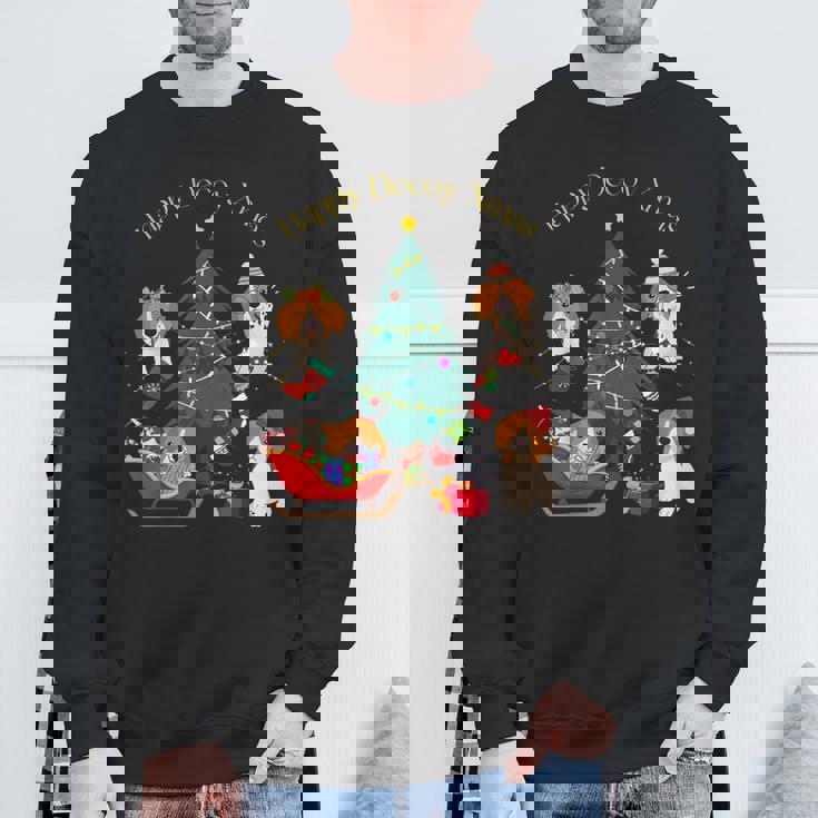 アグリー ハッピーデコピンクリスマス コーイケルホンディエ犬 ダッチデコイスパニエル犬 スウェットシャツ 高齢者への贈り物