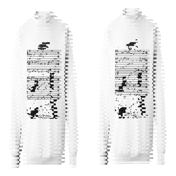 音楽譜上の遊ぶ猫のシルエットデザイン ピアノ音符 遊び心のある猫 猫 ジョーク かわいい 動物好き ギャグ好き スウェットシャツ