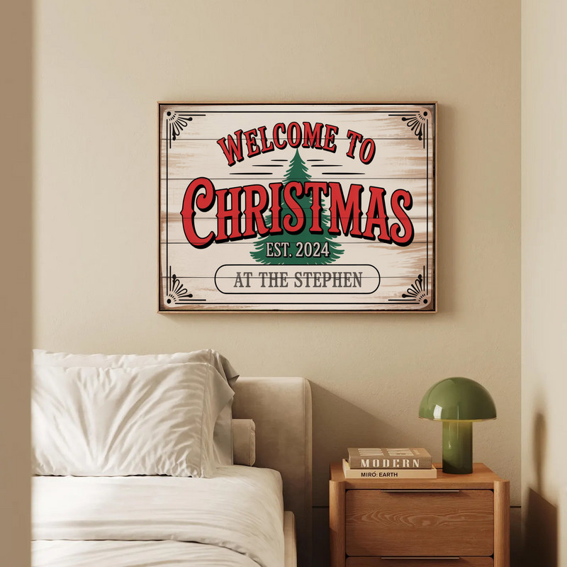 Welcome Christmas canvas wall art featuring pine garland and snowflakes on gray reclaimed wood, horizontal, farmhouse mantel display