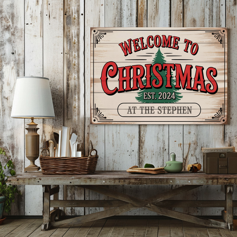 Welcome Christmas canvas wall art, cursive lettering framed by greenery on whitewashed boards, square, warm farmhouse living room decor