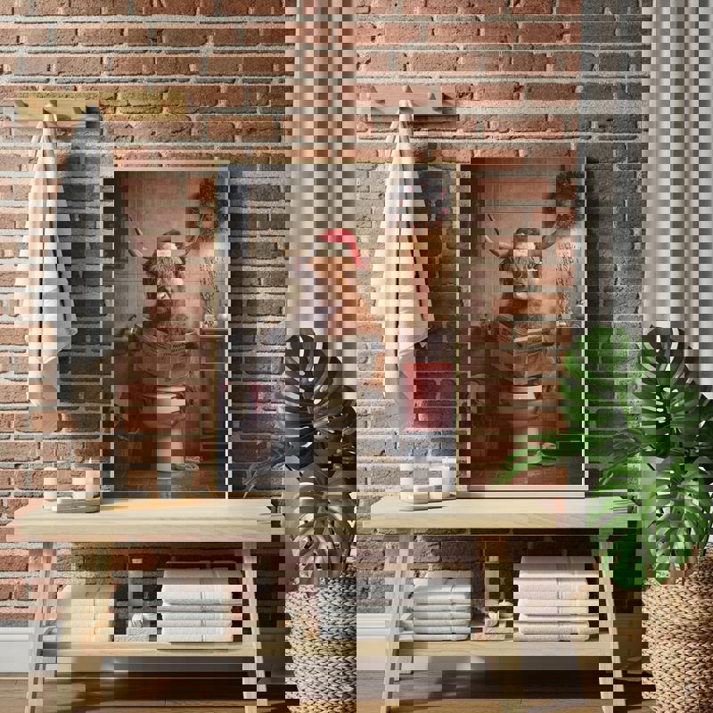 Highland cow wearing Santa hat on toilet reading paper canvas, Christmas bathroom decor, square canvas in rustic neutrals