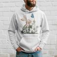 蝶のイースターとデイジーを保持している甘いウサギのウサギ 長袖tシャツ パーカー 彼への贈り物