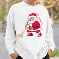 ゴルフをする面白い醜いクリスマスサンタ。 スウェットシャツ 彼への贈り物